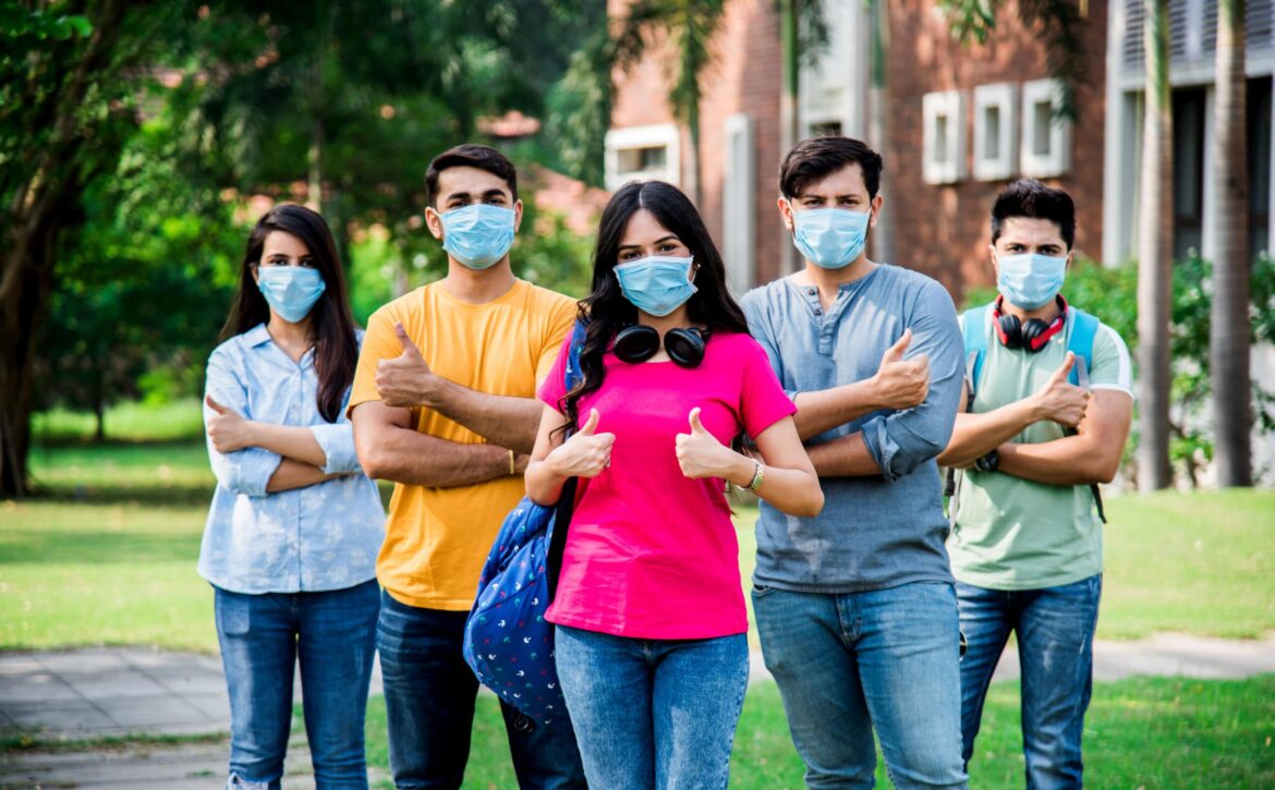 Education after Corona Pandemic - College students wear protective face mask in campus, outdoor